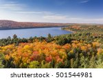 Overlooking a lake surrounded by brilliant fall foliage - Algonquin Provincial Park, Ontario, Canada