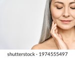 Small photo of Senior older middle aged Asian woman with grey hair and radiant face with perfect skin. Advertising of rejuvenating skincare and makeup for natural radiant glow and healthy skin. Copy space.