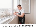 a repairman repairs, adjusts or installs metal-plastic windows in the apartment. glazing of balconies, loggias, verandas in house. production of double-glazed windows to individual sizes.