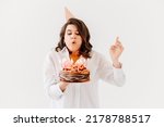 Small photo of a lilt woman with a birthday cake with candles. traditional sweet treat and wish-making for a birthday.