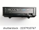 back panel with connectors of Black Universal Projector on a white background. A video projector, an image projector, receives a video signal and projects onto the screen using a lens system.