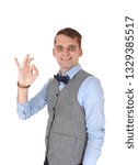 Small photo of An image of a young happy man smiling and showing with his hand a sign, agreeing with the dissension, isolated for white background