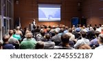 Small photo of Speaker giving a talk in conference hall at business meeting event. Rear view of unrecognizable people in audience at the conference hall. Business and entrepreneurship concept.