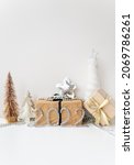 Small photo of Happy New Year 2022. Festive decor - tree, gift, star, tinsel. Empty space for copying decals or other items