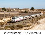 Small photo of Alicante, Spain - February 16, 2022: Talgo train of RENFE in the Sierra del Cid near Alicante, Spain.
