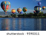 Number of hot air balloons launching over a lake in Colorado Springs, Colorado
