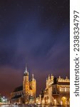 Small photo of Krakow, Poland. Evening Night View Of The St. Mary's Basilica And Cloth Hall Building. Famous Old Landmark Church Of Our Lady Assumed Into Heaven. Saint Mary's Church. UNESCO World Heritage Site.