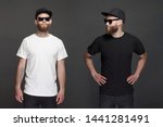 Hipster handsome male model with beard wearing black and white blank t-shirt and a baseball cap with space for your logo