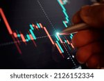 Financial chart with pen, stock analysis data for business background on digital screen. Graphs of the growth of the financial market forex. trading candlestick chart