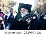 Small photo of Tehran Iran - November 4, 2022, a veiled woman is holding a photo of Khamenei. On the Day of Fighting Arrogance, the Iranian leader's photo is held by a veiled woman.