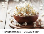 Salt popcorn on the wooden table, selective focus