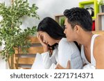 Small photo of Wife and husband heal reconcile from sulk by caressing and hugging together. Caring man make peace and reconcile with lover. Couple in Sulk problems together in white bed.