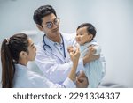 Small photo of Mail pediatrician doctor in white cost gown hold stethoscope exam child infant patient. pediatrician sitting seduce misbehave baby infant for stethoscope checkup in hospital children medical care