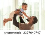 Small photo of Happy african black parents dad father throw baby son on piggyback and neck riding teasing fun near window. Black baby son and daddy enjoy teasing kiss cheek and neck riding at window light