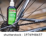 Small photo of Norwich, Norfolk, UK - May 15 2021. Close and selective focus on a bottle of TF2 all weather lubricant used to service and maintain a racing bicycle.