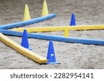 Small photo of Show jumping poles obstacles, barriers, waiting for riders on show jumping training. Horse obstacle course outdoors summertime. Poles in the sand at equestrian center indoors