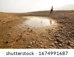 Children and last water source, Drought impact lake dryed no rainfall in season effect of climate change and extreme weather of heat temperature on summer