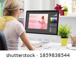 Graphic design artist editing photo on computer