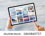 Woman using tablet and browsing beautiful winter photography online