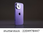 Small photo of Madrid, Spain - September 21, 2022: Newly released iPhone 14 Pro in Deep Purple color on dark background