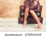 Woman Sitting On Suitcases 