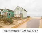 Wooden beach huts at the seaside on Hengistbury Head, Dorset, UK
