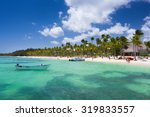 Small photo of Playa BaA¡varo, Dominican Republic- April 19, 2015: Diving boats moored at the beach with palm trees in the high noon