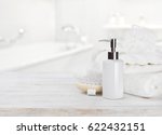 Small photo of Soap dispencer, towels, massager and wisp of bast over blur
