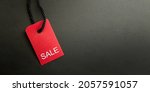 Small photo of Black Friday Sale or Discount banner. Red clothes tag over black background. Modern minimal design with space for text. Template for promotion, advertising, web, social and fashion ads. High quality