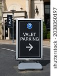 Small photo of Valet parking sign at the entrance to a center with a shallow depth of field