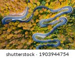 Scenic curvy road seen from a drone in autumn.