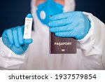Doctor holding passport and negative covid-19 ( rapid antigen SARS-CoV-2 Ag ) test. Coronavirus and safety travel concept.