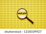 Small photo of small print enlarged with magnifying glass magnifier loupe, business concept
