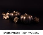 Gold and black luxury pumpkin with gold autumn leaves. Minimalist banner good for thanksgiving and Halloween.