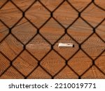 Base on baseball diamond through chainlink fence competition