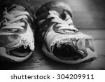Small photo of Old shoes with holes worn down shabby for homeless clothing