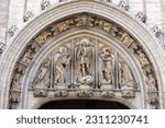 Small photo of Brussels, Belgium - May 17, 2023: Medieval Town Hall in Grand Place, main market in the city. The tympanum of the portal above the main entrance to the building