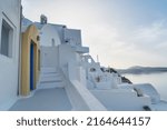 Small photo of traditional greek village Oia of Santorini, street against Aegan sea and caldera, Greece