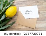 Small photo of Happy Sukkot - religion image of Jewish festival of Sukkot. Traditional symbols Etrog, lulav, hadas, arava on wooden table with thank you note and copy space on white card