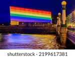 San Sebastian skyline with Kursaal Congress Centre and Auditorium conference center in Spain, decorated with an LGBT Pride rainbow flag at sunset