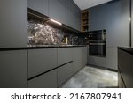 Small photo of Corner view closeup to grey luxury kitchen