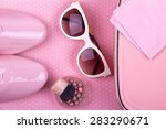 beautiful women's minimal set of fashion accessories on a pink background: shoes, sunglasses, powder and handbag. Place for text. Ideal for blogs or magazines. Mock up.