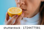 Small photo of Anosmia or smell blindness, loss of the ability to smell, one of the possible symptoms of covid-19, infectious disease caused by corona virus. Woman Trying to Sense Smell of a Lemon