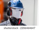 PPE - Industrial Work Safety and Personal Protection Equipment on Display. Safety helmet and anti-noise earmuffs