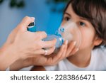 Pulmonologist Helping Little Boy with Aero chamber. Pediatric pulmonologist, medical doctor who specializes in the diagnosis and treatment of diseases and disorders of respiratory system 