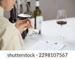 Wine tasting. A woman enjoys a red wine tasting, savoring the wine's flavors and aromas.