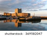 Medieval Norman Castle in Carrickfergus, Northern Ireland, and its reflection in water at sunset.