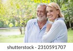 Small photo of Happy old elderly caucasian couple smiling in park on sunny day, hoot senior couple relax in spring summer time. Healthcare lifestyle elderly retirement love couple together valentines day concept