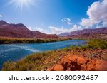Lee's  Ferry is a historic boat ferry across the Colorado River. Amazing wildlife. USA. Wide river and shores of red sandstone. Bright and hot sunny day. The concept of extreme and photo tourism
