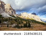 The Falzarego pass. Mountain range in the Eastern Alps. The clouds are flying across the sky. Sunset in the colorful rocks of the Dolomites. 